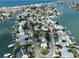 Aerial view showcases this waterfront home, surrounded by lush landscaping and serene canals at 13004 Boca Ciega Ave, Madeira Beach, FL 33708
