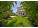 Secluded backyard with lush landscaping, a charming patio area, and comfortable outdoor seating at 13004 Boca Ciega Ave, Madeira Beach, FL 33708
