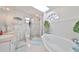 Bright bathroom with walk-in shower, soaking tub, and skylight at 13004 Boca Ciega Ave, Madeira Beach, FL 33708
