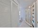 Bathroom with toilet, glass door shower, and closet with ample storage at 13004 Boca Ciega Ave, Madeira Beach, FL 33708