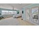 Bright bedroom boasts hardwood floors, water view, and french door access to outdoor deck at 13004 Boca Ciega Ave, Madeira Beach, FL 33708