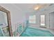 Bright bedroom with modern decor featuring a mirrored dresser and accent rug at 13004 Boca Ciega Ave, Madeira Beach, FL 33708
