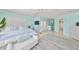 Bright bedroom boasts hardwood floors, french doors, and ensuite bathroom access at 13004 Boca Ciega Ave, Madeira Beach, FL 33708