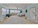 Bright bedroom boasts hardwood floors, water view, and french door access to outdoor deck at 13004 Boca Ciega Ave, Madeira Beach, FL 33708