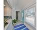 Inviting entryway with bright blue door, white trim, and view of the updated shower at 13004 Boca Ciega Ave, Madeira Beach, FL 33708