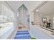 Bright entryway with a spiral staircase and views of the living spaces at 13004 Boca Ciega Ave, Madeira Beach, FL 33708