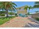 Beautiful two-story home with lush landscaping, inviting blue door and brick driveway at 13004 Boca Ciega Ave, Madeira Beach, FL 33708