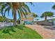 Beautiful two-story home with lush landscaping, inviting blue door and brick driveway at 13004 Boca Ciega Ave, Madeira Beach, FL 33708