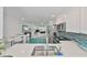 Modern kitchen with stainless steel appliances, backsplash, and open view to living areas at 13004 Boca Ciega Ave, Madeira Beach, FL 33708