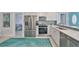 Modern kitchen with stainless steel appliances, backsplash, and view to the entryway at 13004 Boca Ciega Ave, Madeira Beach, FL 33708