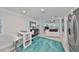 Bright living room featuring dining area, modern decor, and access to sunroom at 13004 Boca Ciega Ave, Madeira Beach, FL 33708