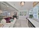 Bright living room with modern furnishings, fireplace and access to the kitchen and staircase at 13004 Boca Ciega Ave, Madeira Beach, FL 33708