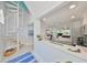 A view of the spiral staircase that leads to a modern kitchen and open living area at 13004 Boca Ciega Ave, Madeira Beach, FL 33708