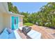 Cozy patio with comfortable seating, a stylish table, and tropical foliage creating a tranquil outdoor space at 13004 Boca Ciega Ave, Madeira Beach, FL 33708