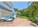 Relaxing patio featuring cozy seating, a stylish fire pit, and vibrant landscaping for outdoor enjoyment at 13004 Boca Ciega Ave, Madeira Beach, FL 33708