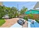 Private patio with comfortable seating, a charming garden, and a peaceful atmosphere for outdoor relaxation at 13004 Boca Ciega Ave, Madeira Beach, FL 33708