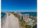 Stunning aerial view of beachfront condos with pool and direct beach access on a clear, sunny day at 1380 Gulf Blvd # 1008, Clearwater Beach, FL 33767