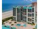 Aerial view of a beachfront condo building with pool and ocean views at 1380 Gulf Blvd # 1008, Clearwater Beach, FL 33767