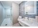 Bathroom with modern fixtures and decorative stone tile wall above marble sink at 1380 Gulf Blvd # 1008, Clearwater Beach, FL 33767