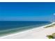 Expansive beachfront with white sand and clear blue water under a bright, cloudless sky at 1380 Gulf Blvd # 1008, Clearwater Beach, FL 33767