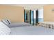 Bright bedroom showcasing beds, a crib, and access to a balcony with stunning water views at 1380 Gulf Blvd # 1008, Clearwater Beach, FL 33767