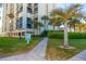 Exterior view of condo building with balconies, palm trees, and landscaped walkway at 1380 Gulf Blvd # 1008, Clearwater Beach, FL 33767