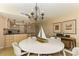Dining area showcases table with seating for six, decorative lighting, and views into the kitchen at 1380 Gulf Blvd # 1008, Clearwater Beach, FL 33767