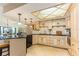 Charming kitchen with tiled floors, granite countertops, custom cabinetry, and stainless dishwasher at 1380 Gulf Blvd # 1008, Clearwater Beach, FL 33767
