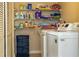 Convenient laundry room with shelving, washer, and dryer to tackle laundry tasks easily at 1380 Gulf Blvd # 1008, Clearwater Beach, FL 33767
