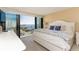 Bright main bedroom featuring a large bed, water views, and access to a private balcony at 1380 Gulf Blvd # 1008, Clearwater Beach, FL 33767