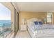 Inviting bedroom featuring a king bed with balcony access and scenic water views at 1380 Gulf Blvd # 1008, Clearwater Beach, FL 33767