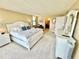 Bright main bedroom with a king size bed with access to an ensuite bathroom and a desk workspace at 1380 Gulf Blvd # 1008, Clearwater Beach, FL 33767