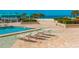 Resort-style pool area with lounge chairs, sun umbrellas, and beautiful ocean views at 1380 Gulf Blvd # 1008, Clearwater Beach, FL 33767