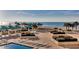 Relaxing pool area with lounge chairs, cabanas, lush landscaping and Gulf of Mexico view at 1380 Gulf Blvd # 1008, Clearwater Beach, FL 33767