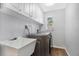 Bright laundry room with white cabinets, a utility sink, and modern appliances at 2499 Indigo Dr, Clearwater, FL 33763