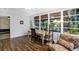 Sunroom with hardwood floors, comfortable seating, and a workspace at 2499 Indigo Dr, Clearwater, FL 33763