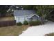 Quaint light blue house with mature landscaping at 14255 Walsingham Rd, Largo, FL 33774