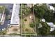 Vacant lot surrounded by trees and buildings at 14255 Walsingham Rd, Largo, FL 33774
