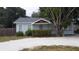 Charming light blue house with a well-maintained yard at 14255 Walsingham Rd, Largo, FL 33774