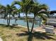 Private dock with boat lift and seating area, offering waterfront living at 14845 N Bayshore Dr, Madeira Beach, FL 33708