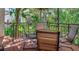 Balcony seating area with views of lush tropical landscaping and a table at 240 Windward Psge # 602, Clearwater Beach, FL 33767