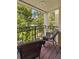 Comfortable balcony area with seating and views of the lush greenery at 240 Windward Psge # 602, Clearwater Beach, FL 33767