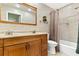 Bathroom with double sinks, wooden vanity, and shower-tub combination at 240 Windward Psge # 602, Clearwater Beach, FL 33767