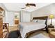 Cozy bedroom featuring a ceiling fan, a comfortable queen bed, and ensuite bathroom access at 240 Windward Psge # 602, Clearwater Beach, FL 33767