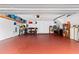 Spacious garage area with room for storage and a red painted floor at 240 Windward Psge # 602, Clearwater Beach, FL 33767