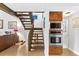 Hallway with a wooden staircase with stainless steel kitchen appliances and a living room view at 240 Windward Psge # 602, Clearwater Beach, FL 33767