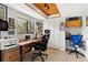 Bright home office with wood ceiling, ample natural light, wooden desk and built-in storage at 240 Windward Psge # 602, Clearwater Beach, FL 33767