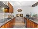 Kitchen featuring granite countertops, wooden cabinets, stainless steel appliances, and ample counter space at 240 Windward Psge # 602, Clearwater Beach, FL 33767