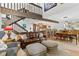 Cozy living room boasts hardwood floors, a staircase, and an open floor plan to the kitchen and dining room at 240 Windward Psge # 602, Clearwater Beach, FL 33767