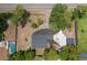 Aerial view of the home showing the roof, the surrounding landscaping, driveway, and nearby pool at 7414 Van Dyke Rd, Odessa, FL 33556